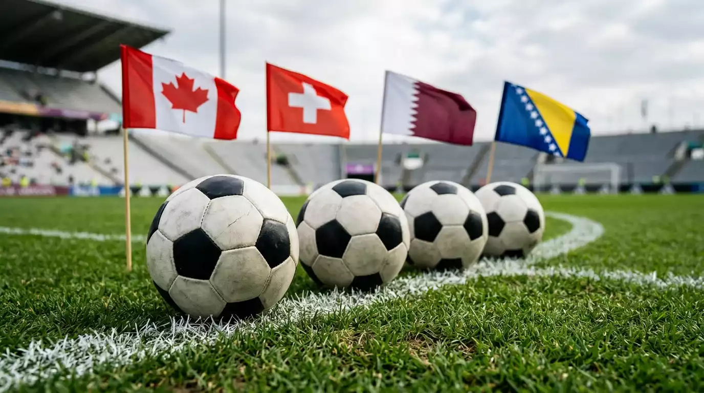 Quatre ballons de football posés sur la ligne médiane d'un terrain devant les drapeaux du Canada, de la Suisse, du Qatar et de la Bosnie-Herzégovine